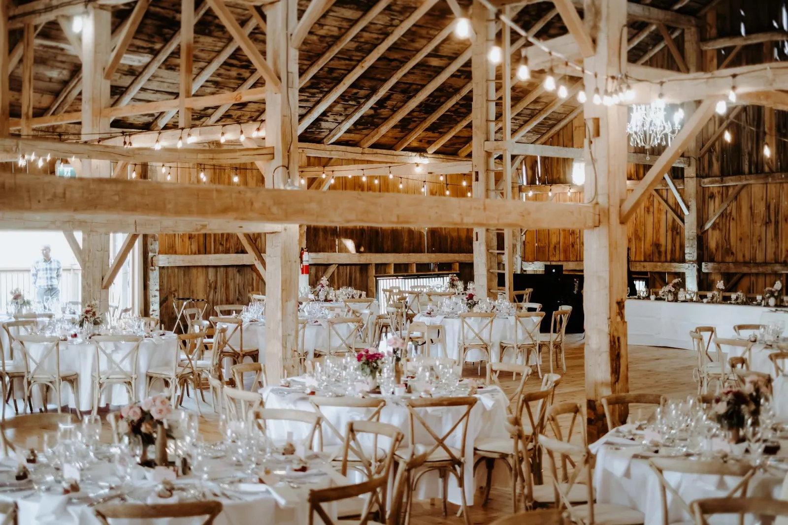 Guests enjoying a farm wedding reception under string lights