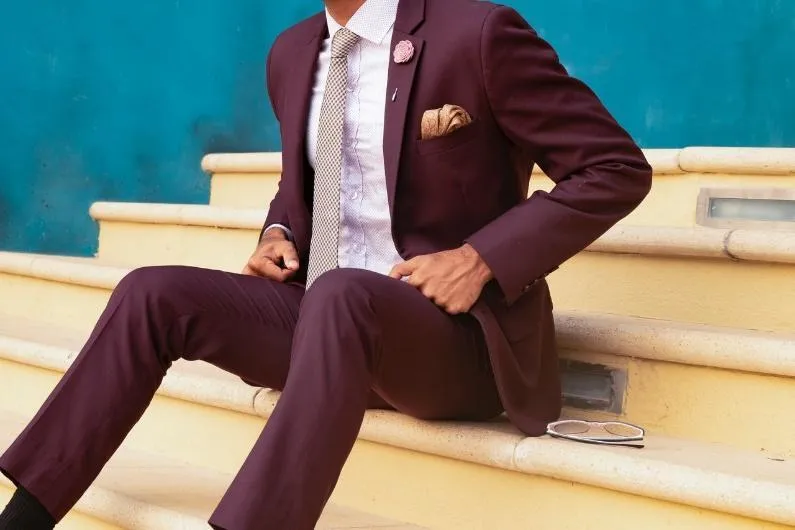 Groom in a tailored suit preparing for the wedding day